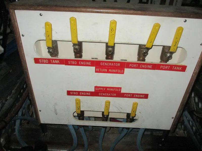 Slide: The Image of Control panel with yellow levers on a 1994 Grand Banks 49 Motoryacht. - 31