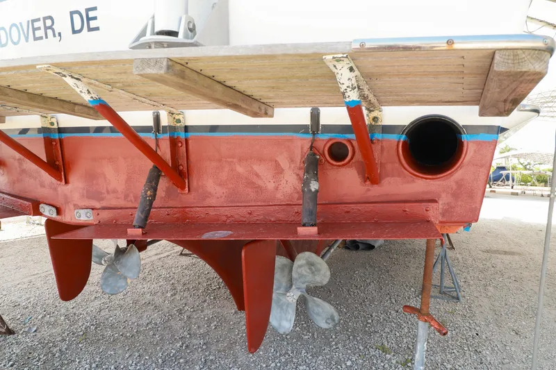 Slide: The Image of 1994 Grand Banks 49 Motoryacht stern view, showcasing propellers and rudders on dry dock. - 33