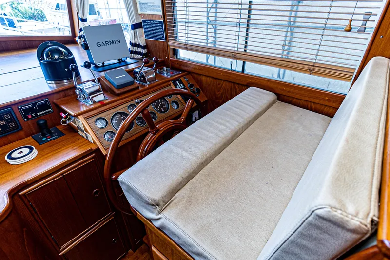 Slide: The Image of 1994 Grand Banks 49 Motoryacht helm with wooden steering wheel and navigation equipment. - 42