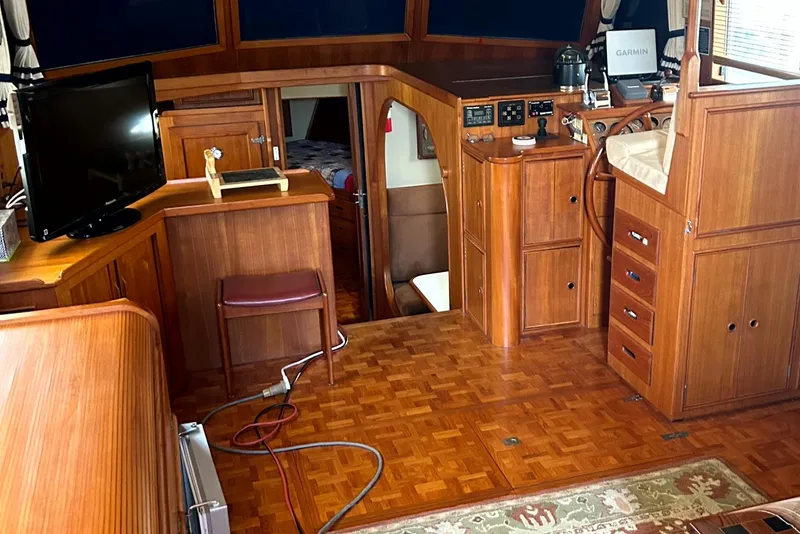 Slide: The Image of Interior of 1994 Grand Banks 49 Motoryacht with wood paneling and navigation equipment. - 5
