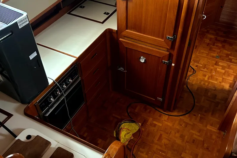 Slide: The Image of 1994 Grand Banks 49 Motoryacht kitchen with wood cabinetry and parquet flooring. - 6