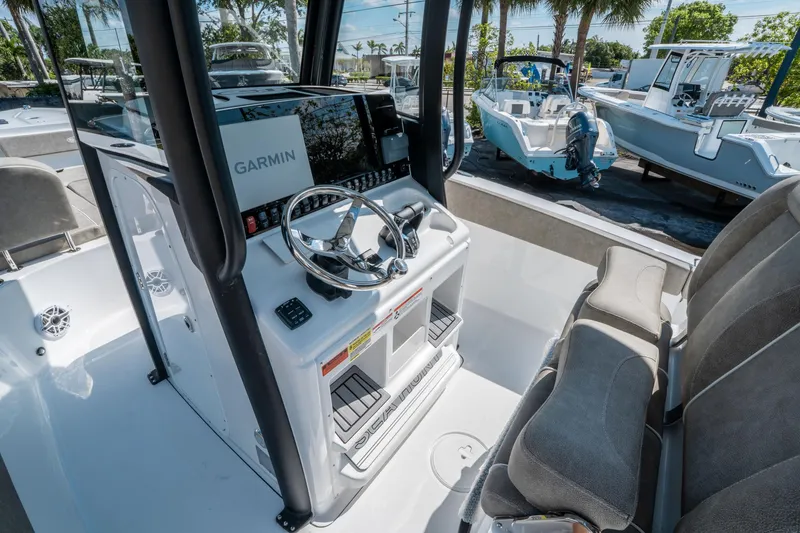 Slide: The Image of 2025 Sea Hunt Gamefish 25 boat interior with Garmin navigation system and comfortable seating. - 19