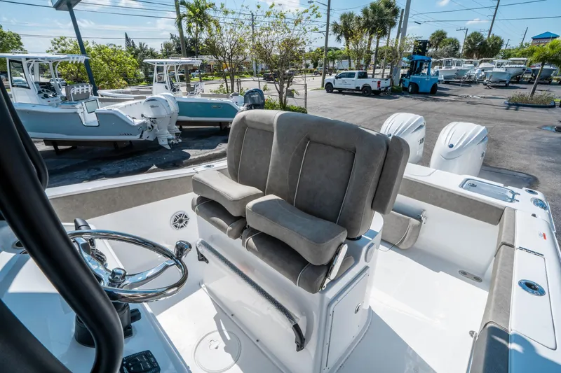 Slide: The Image of 2025 Sea Hunt Gamefish 25 boat interior with dual seats and steering wheel. - 21