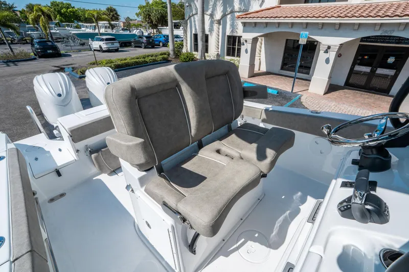 Slide: The Image of 2025 Sea Hunt Gamefish 25 boat interior with dual seats and steering wheel. - 23