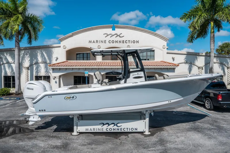 Slide: The Image of 2025 Sea Hunt Gamefish 25 boat displayed at Marine Connection dealership. - 1