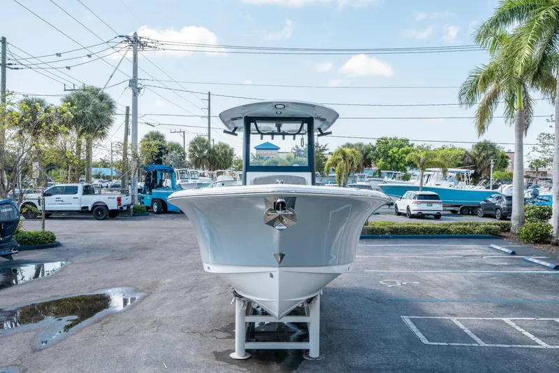 Slide: The Image of 2025 Sea Hunt Gamefish 25 boat displayed in a parking lot with palm trees. - 7