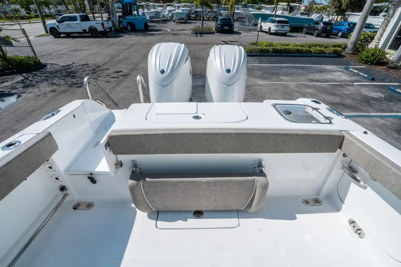 Slide: The Image of 2025 Sea Hunt Gamefish 25 boat interior with dual engines and seating area. - 10