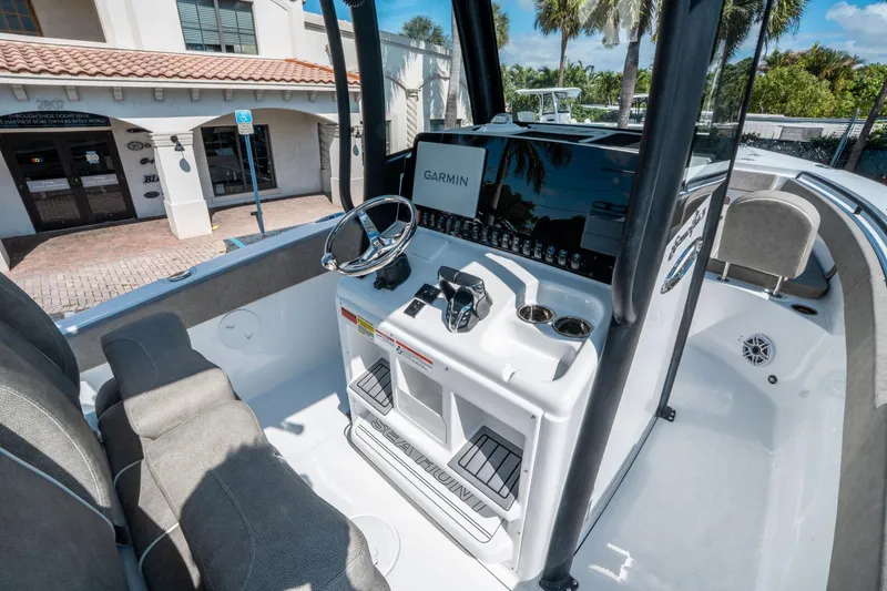 Slide: The Image of 2025 Sea Hunt Gamefish 25 boat interior with Garmin navigation system and comfortable seating. - 20