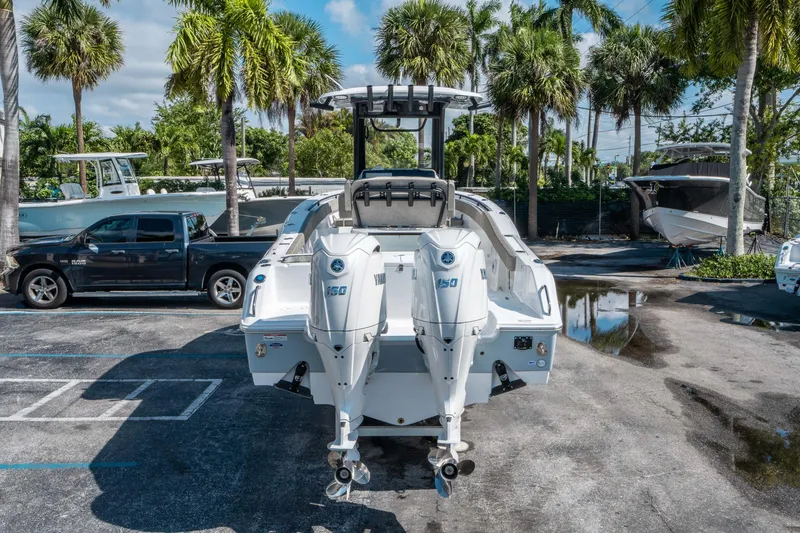 Slide: The Image of 2025 Sea Hunt Gamefish 25 with dual Yamaha engines, parked near palm trees. - 3