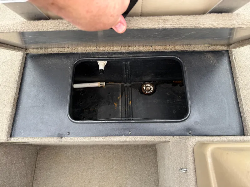 Slide: The Image of Open storage compartment in 1989 Fisher 16 Pro Avenger SC boat interior. - 13