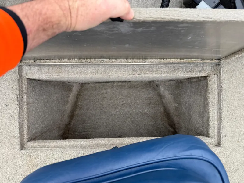 Slide: The Image of Open storage compartment in 1989 Fisher 16 Pro Avenger SC boat. - 14