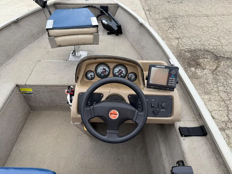 Slide: The Image of 1989 Fisher 16 Pro Avenger SC boat dashboard with steering wheel and gauges. - 15