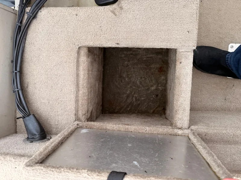 Slide: The Image of Carpeted storage compartment in a 1989 Fisher 16 Pro Avenger SC boat. - 20