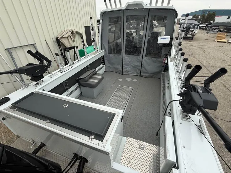 Slide: The Image of 2023 Hewescraft 240 Ocean Pro ET HT boat interior with fishing rod holders and seating. - 11