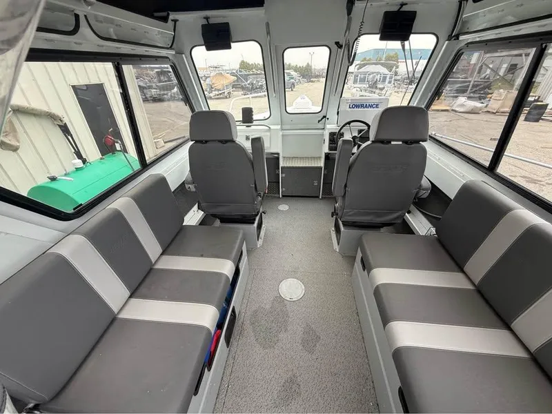 Slide: The Image of 2023 Hewescraft 240 Ocean Pro ET HT interior with seating and helm, showcasing spacious design. - 12