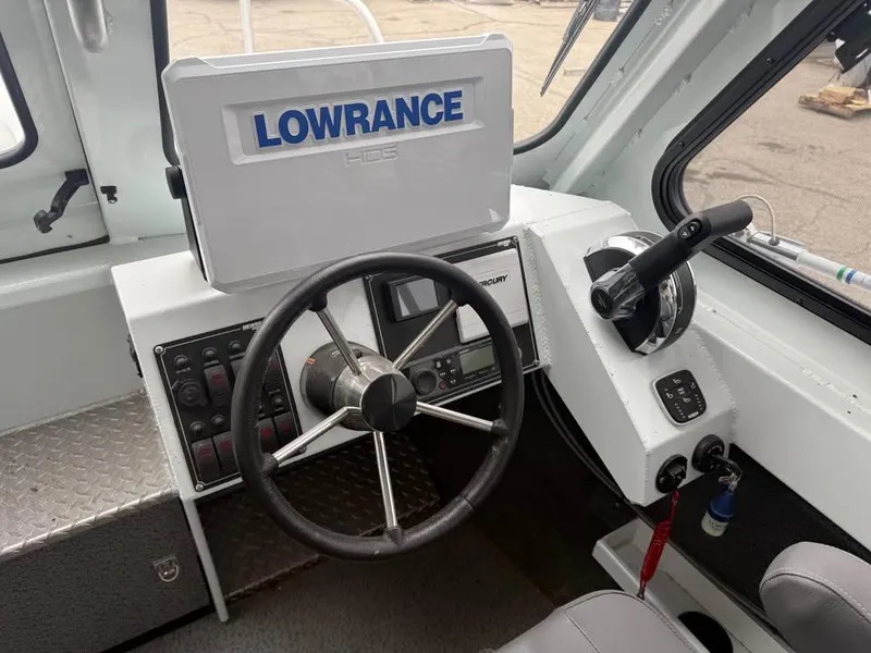 Slide: The Image of 2023 Hewescraft 240 Ocean Pro ET HT boat cockpit with Lowrance navigation system. - 13