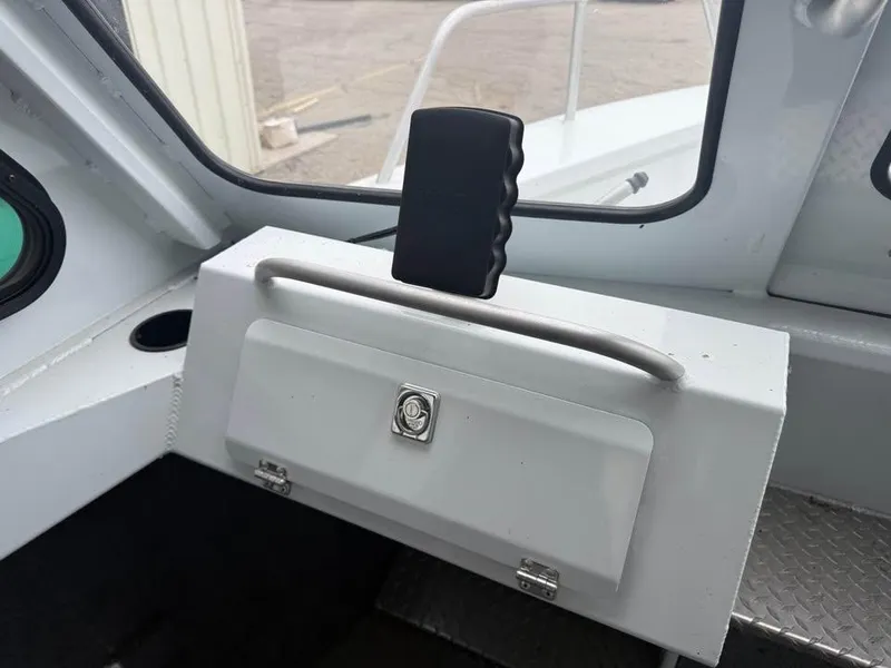 Slide: The Image of 2023 Hewescraft 240 Ocean Pro ET HT interior with storage compartment and handle. - 14