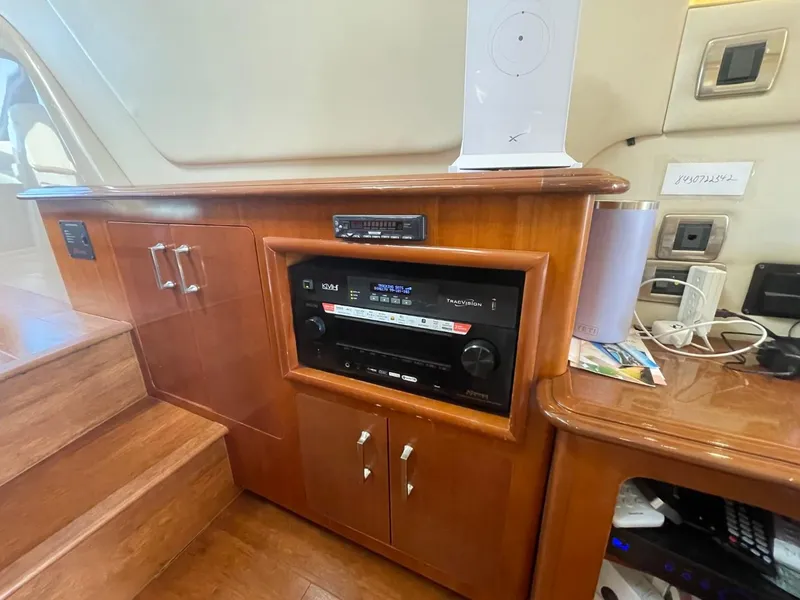 Slide: The Image of Interior of 2006 Carver 56 Voyager yacht with wooden cabinetry and audio equipment. - 23
