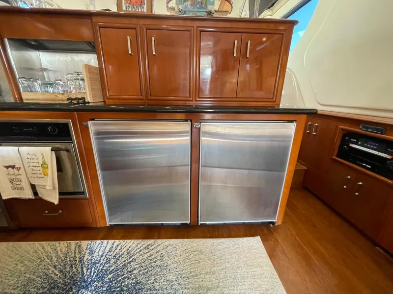 Slide: The Image of 2006 Carver 56 Voyager yacht kitchen with stainless steel appliances and wooden cabinetry. - 28