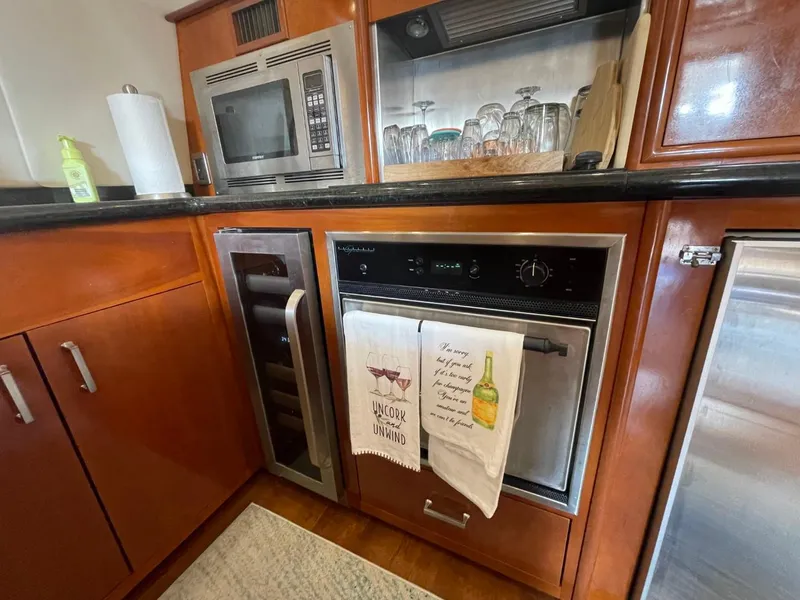 Slide: The Image of Kitchen area in a 2006 Carver 56 Voyager yacht with modern appliances. - 33