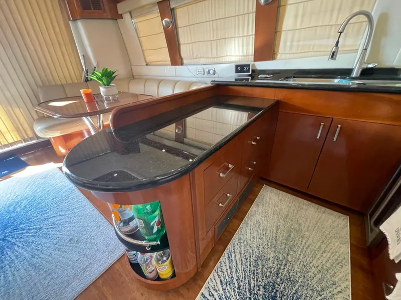 Slide: The Image of Luxurious 2006 Carver 56 Voyager yacht interior with modern kitchen and dining area. - 34