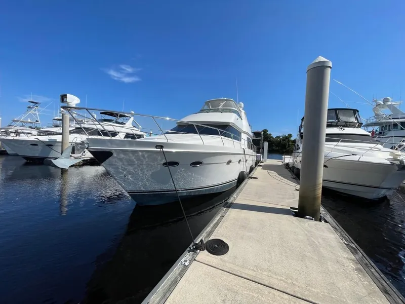 Slide: The Image of 2006 Carver 56 Voyager yacht docked at marina under clear blue sky. - 9