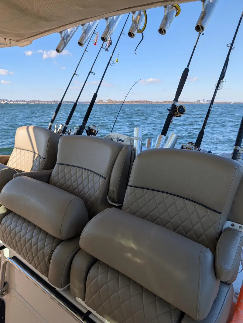 Slide: The Image of Luxury seating on 2012 Grady-White Canyon 366 boat with fishing rods in background. - 2
