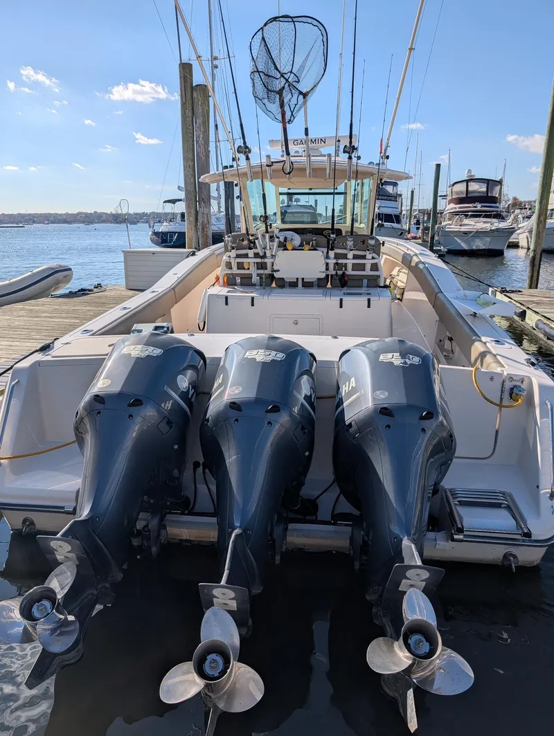 Slide: The Image of 2012 Grady-White Canyon 366 boat with triple Yamaha outboard engines docked at marina. - 3