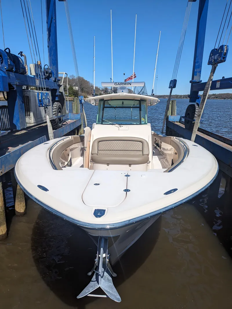 Slide: The Image of 2012 Grady-White Canyon 366 boat docked, front view, in a marina setting. - 4