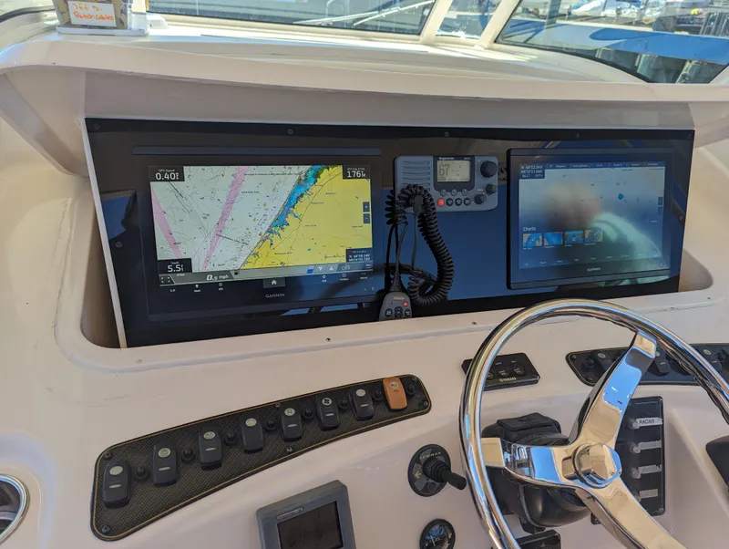 Slide: The Image of Control panel of 2012 Grady-White Canyon 366 boat with navigation screens and steering wheel. - 5