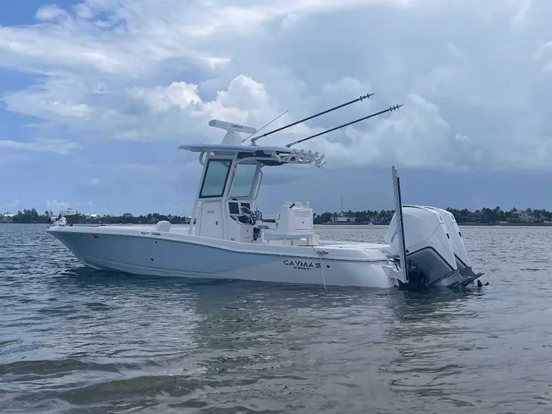 Slide: The Image of 2024 Caymas 281 HB boat on calm water under a cloudy sky. - 0