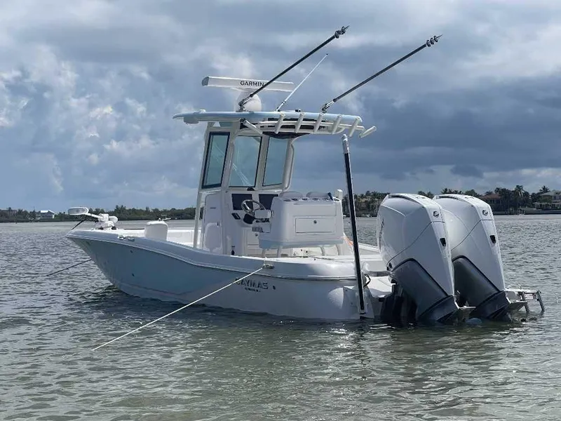 Slide: The Image of 2024 Caymas 281 HB boat with dual outboard motors on calm water. - 2