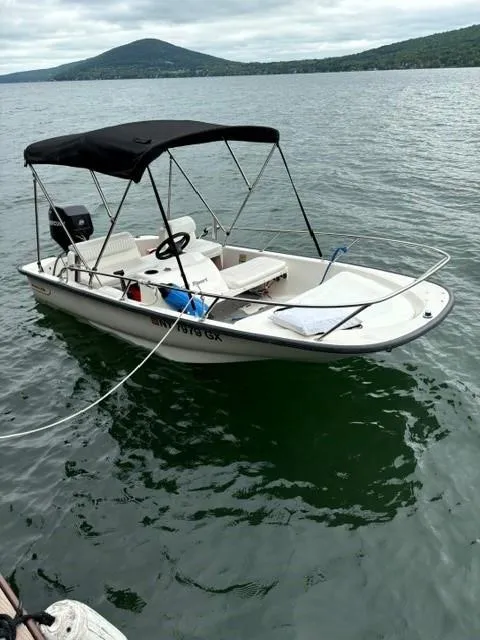 Slide: The Image of 2007 Boston Whaler 130 Sport boat on a lake with a canopy. - 3