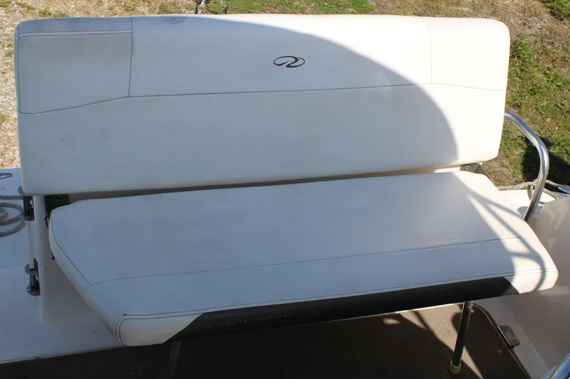 Slide: The Image of White cushioned bench seat on 2006 Regal 2565 Window Express boat. - 10