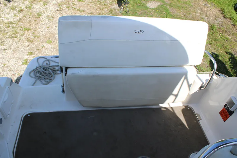 Slide: The Image of 2006 Regal 2565 Window Express boat seating area with white upholstery and deck view. - 11