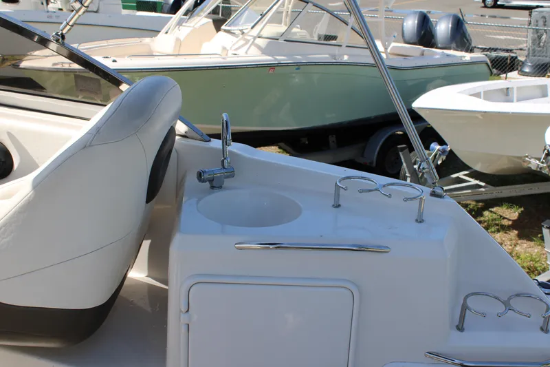 Slide: The Image of 2006 Regal 2565 Window Express boat interior with sink and seating area. - 13