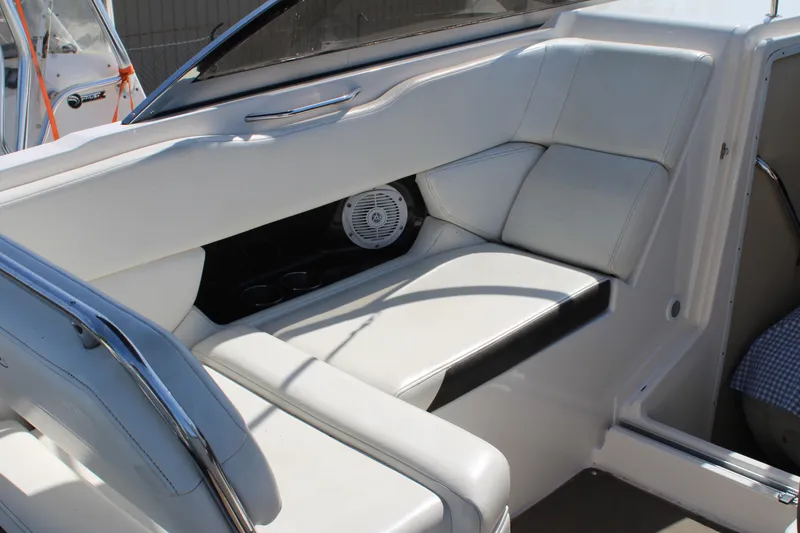 Slide: The Image of 2006 Regal 2565 Window Express boat interior with white seating and speaker. - 14