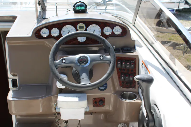 Slide: The Image of 2006 Regal 2565 Window Express boat dashboard with steering wheel and instrument panel. - 16