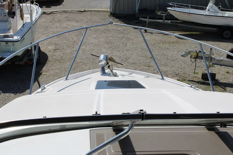 Slide: The Image of 2006 Regal 2565 Window Express boat bow view in a marina setting. - 17