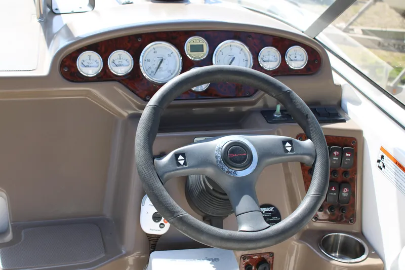 Slide: The Image of 2006 Regal 2565 Window Express boat dashboard with steering wheel and gauges. - 18