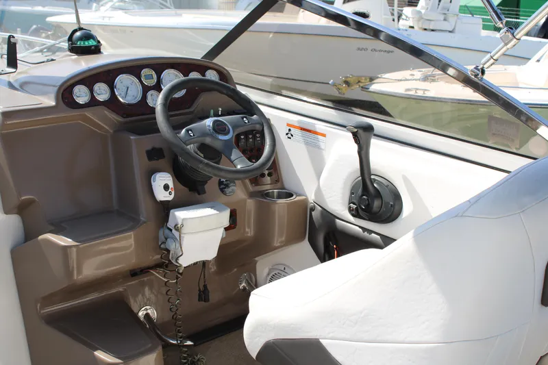 Slide: The Image of 2006 Regal 2565 Window Express boat cockpit with steering wheel and control panel. - 20