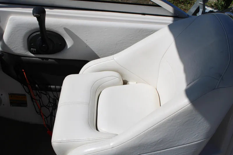 Slide: The Image of White leather seat in 2006 Regal 2565 Window Express boat cockpit. - 22