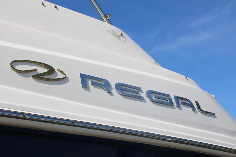 Slide: The Image of 2006 Regal 2565 Window Express boat with logo against blue sky. - 3