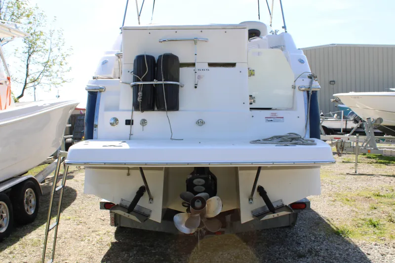 Slide: The Image of 2006 Regal 2565 Window Express boat, rear view with dual propellers and swim platform. - 4