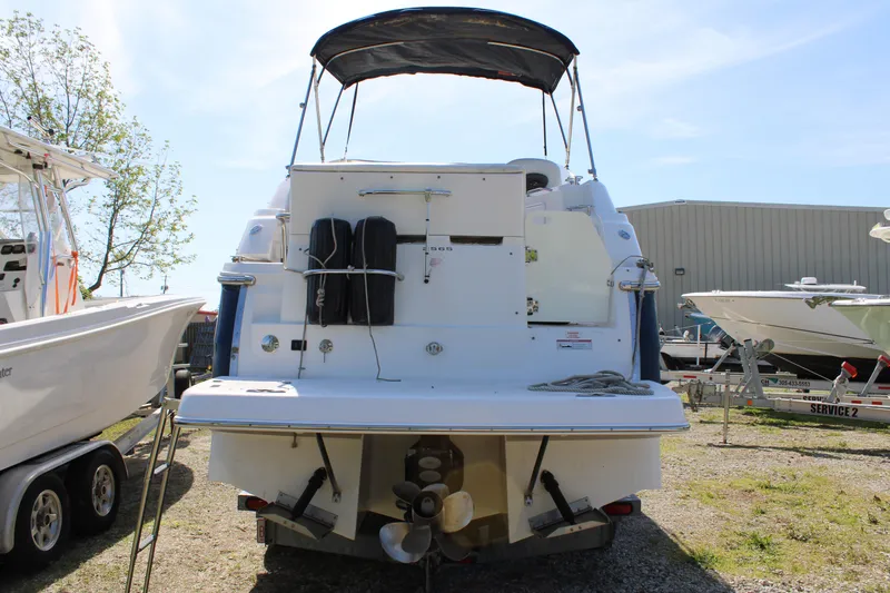 Slide: The Image of 2006 Regal 2565 Window Express boat, rear view, docked outdoors. - 5