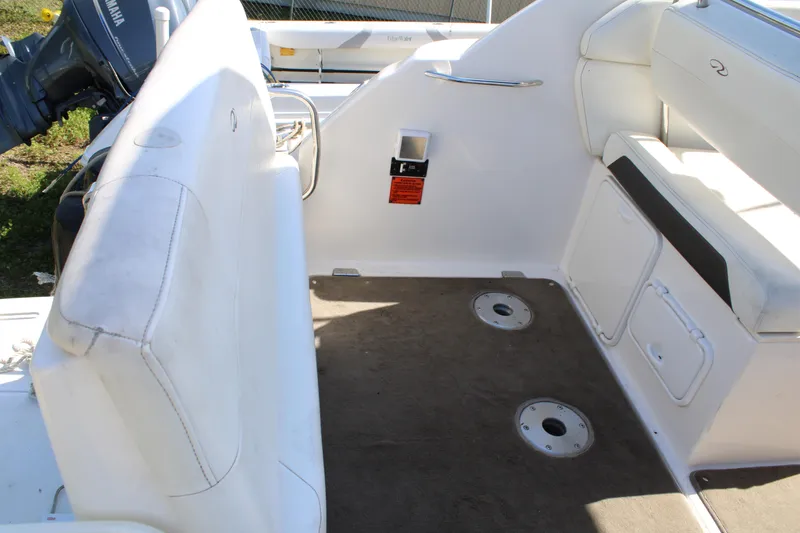 Slide: The Image of 2006 Regal 2565 Window Express boat interior with seating and storage compartments. - 8