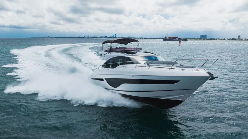 Slide: The Image of 2022 Princess S66 yacht cruising on open water, creating a dynamic wake. - 1