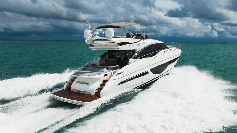 Slide: The Image of Luxurious 2022 Princess S66 yacht cruising on turquoise ocean waters. - 12