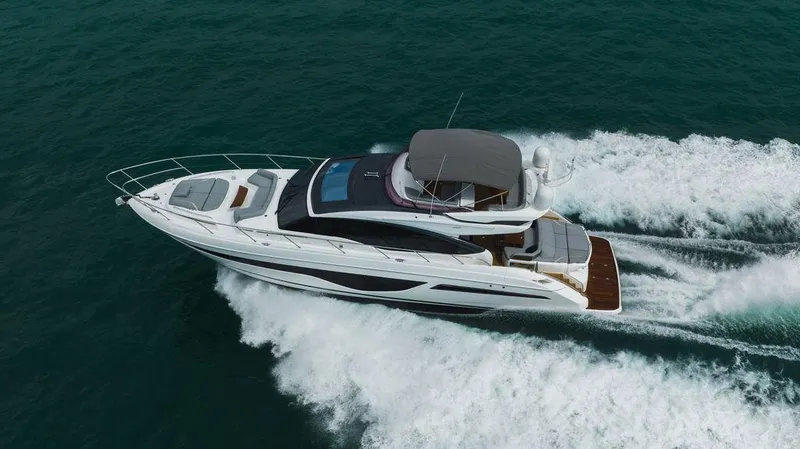 Slide: The Image of 2022 Princess S66 yacht cruising on open water, aerial view. - 22