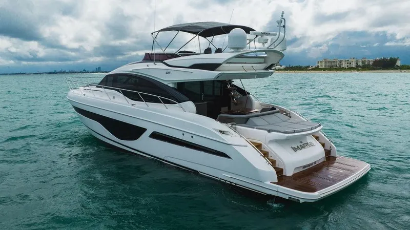 Slide: The Image of 2022 Princess S66 yacht cruising on turquoise waters under a cloudy sky. - 30